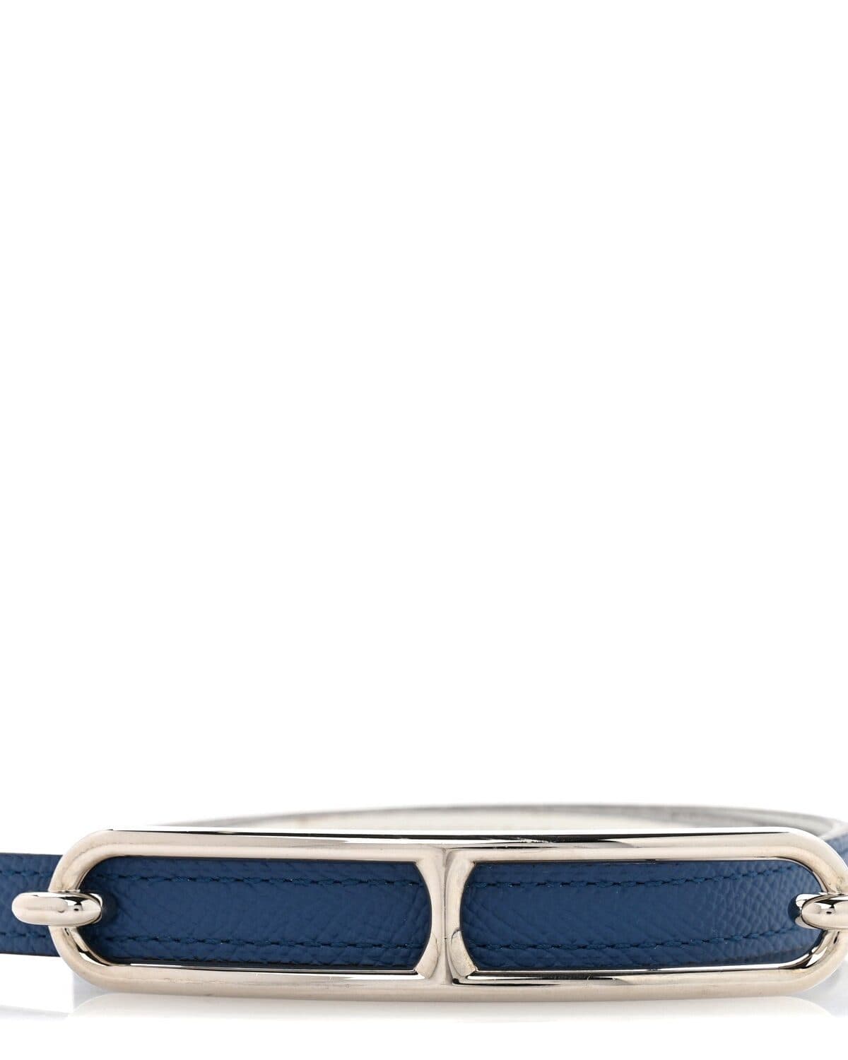 Enamel bag charm photographed on a neutral ground