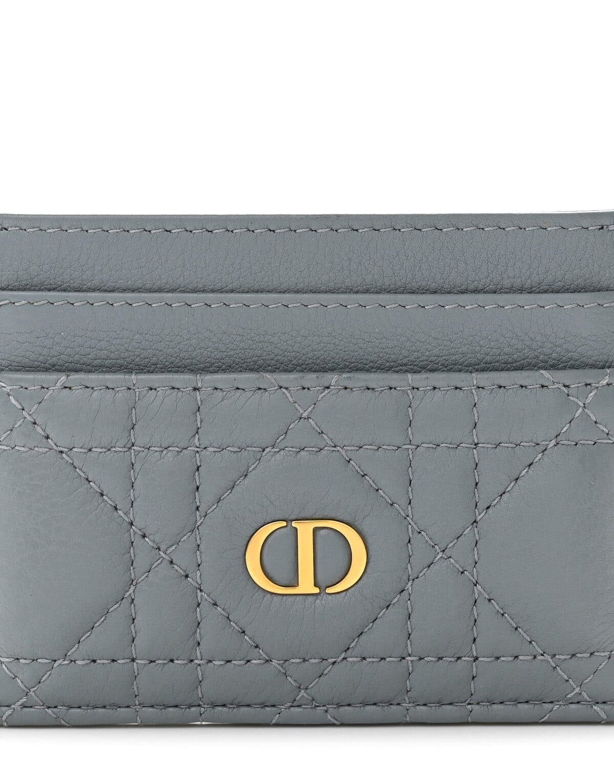 Monogram canvas key pouch photographed on a neutral ground
