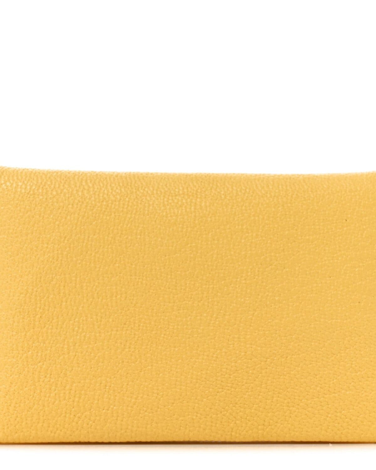 Wallets and card holders laid flat on a warm neutral ground