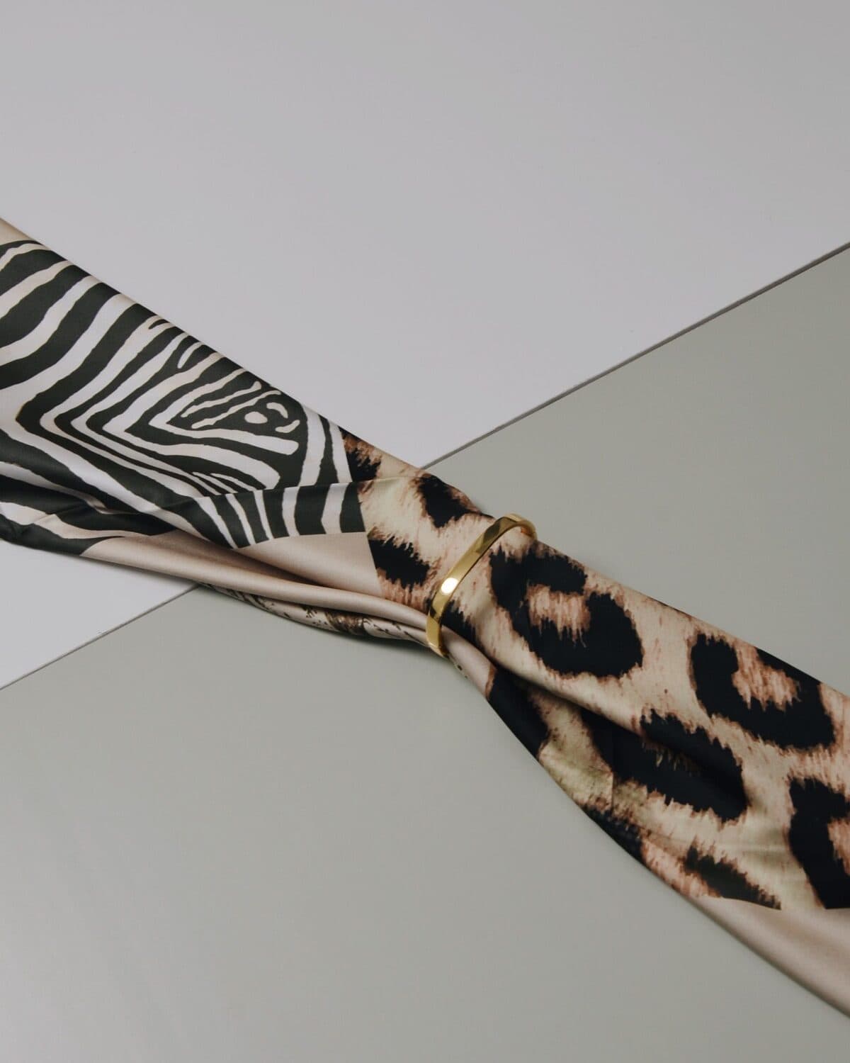 Printed silk twill scarf photographed on a neutral ground