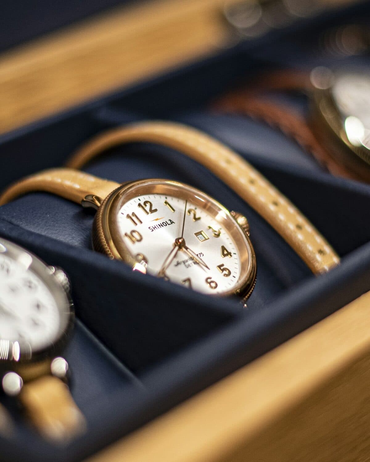 Wristwatch with a leather strap photographed close in warm light